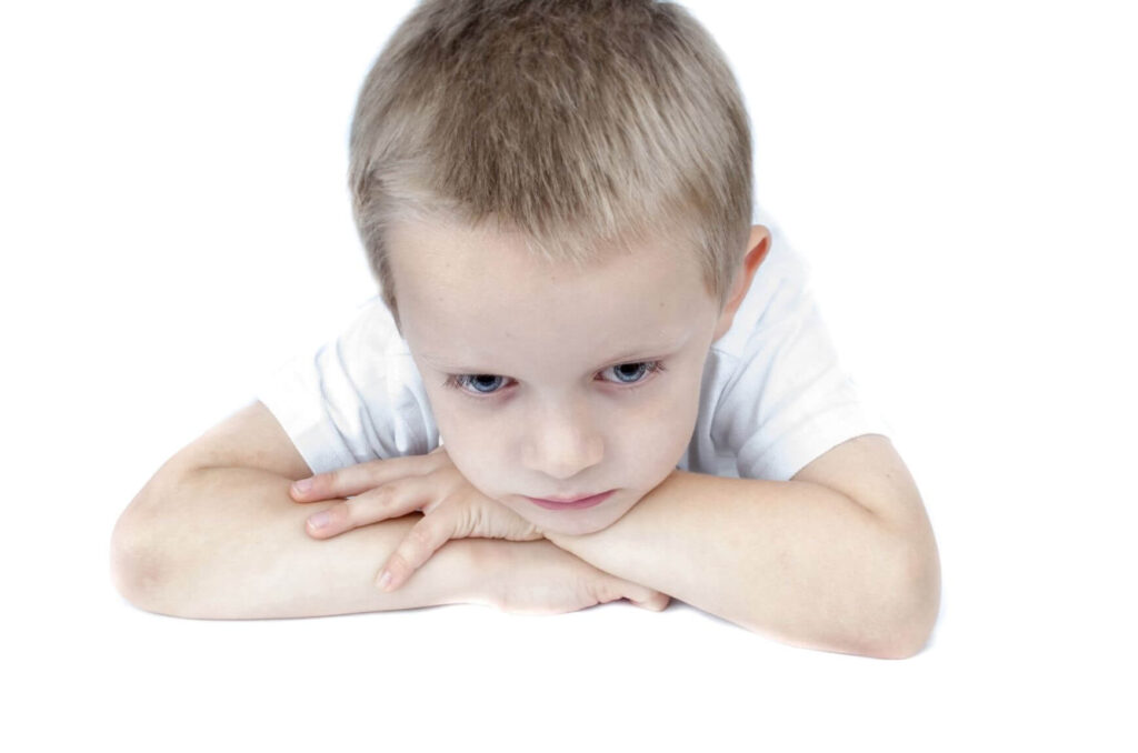 Little boy with head on arms. Help your child manage anxiety.