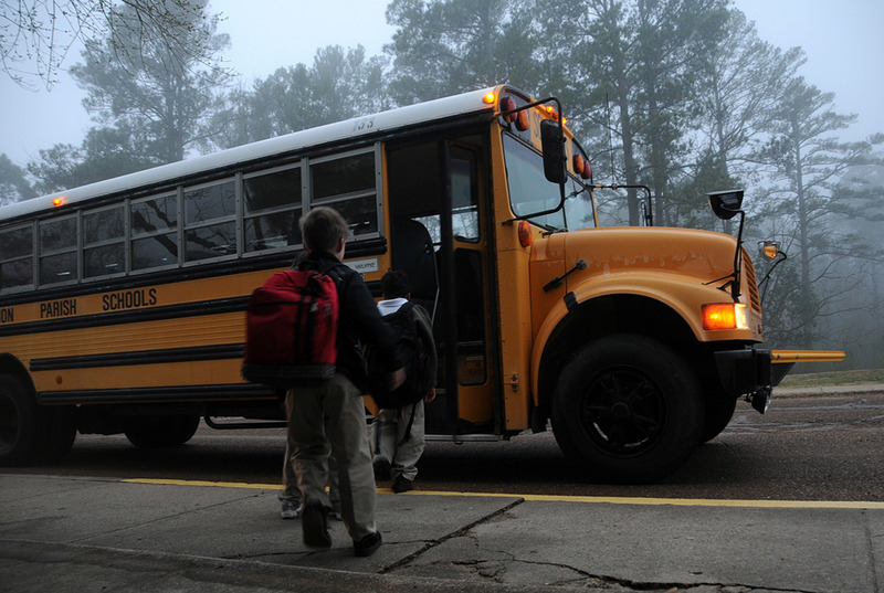 Boy entering a school bus. Prepare your child with autism/ADHD for a new school year.