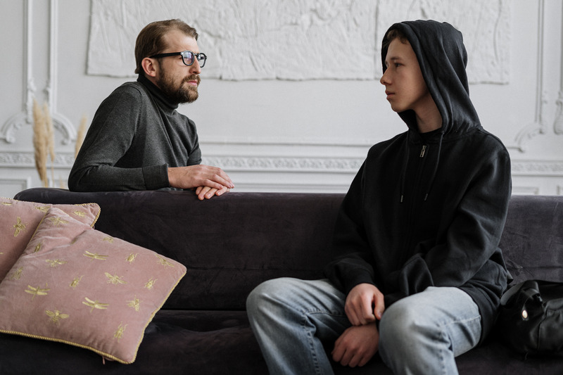 Teenage boy talking to therapist. How do you find a therapist for your child?