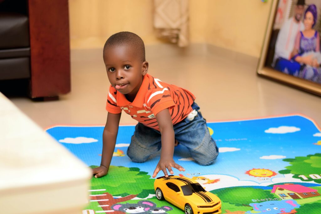 Boy on car mat. Find childcare for your child with autism.