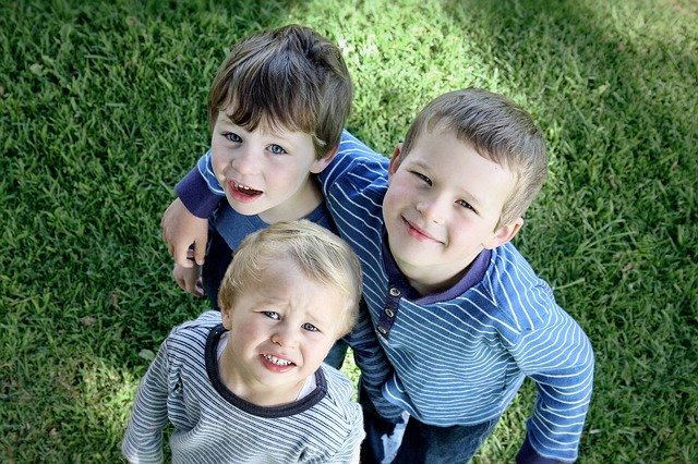 Three brothers standing together. Support siblings of children with autism.