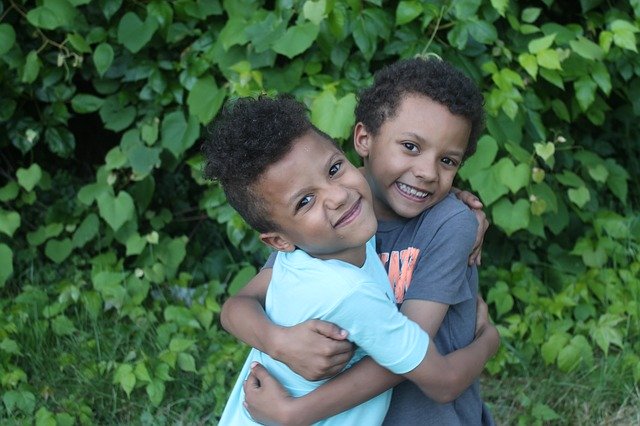 Two brothers hugging. Support siblings of children with autism.