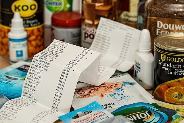 Grocery receipt surrounded by cans of food. You can overcome the financial burden of autism.