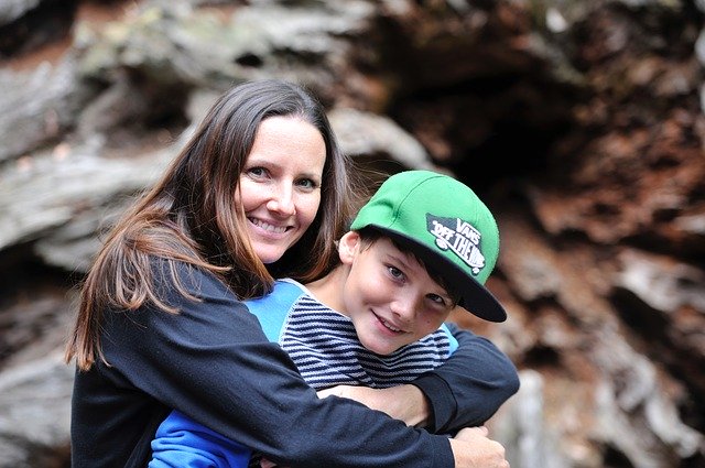 Mother and son sitting in front of rocks. Do you need a special needs trust for your autistic child?