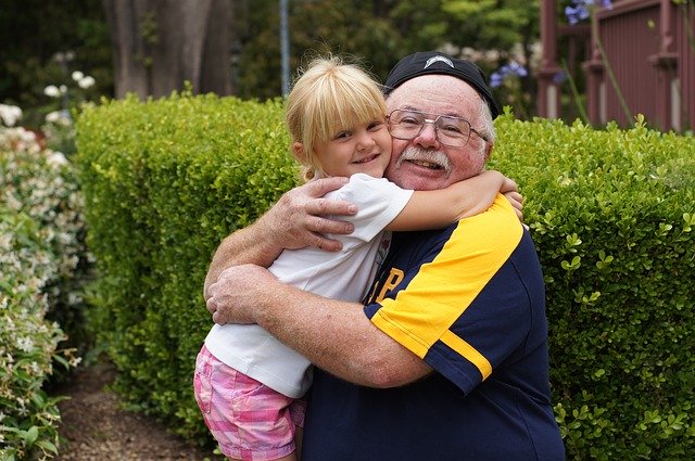 Grandfather hugging granddaughter. Creating a support network for families with autistic/ADHD children.