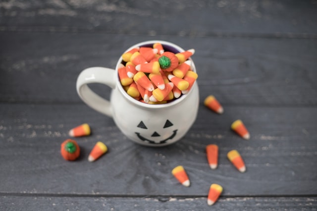 Candy corn in pumpkin mug. Halloween for autism.