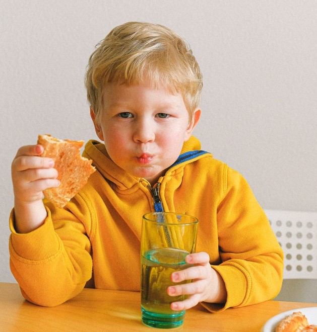 Boy eating. Routines are important for children with autism.