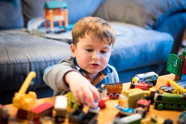 Boy playing with toy cars. Routines are important for children with autism.