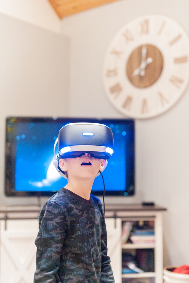 Boy wearing virtual reality headset. Do video games offer benefits for children with autism?