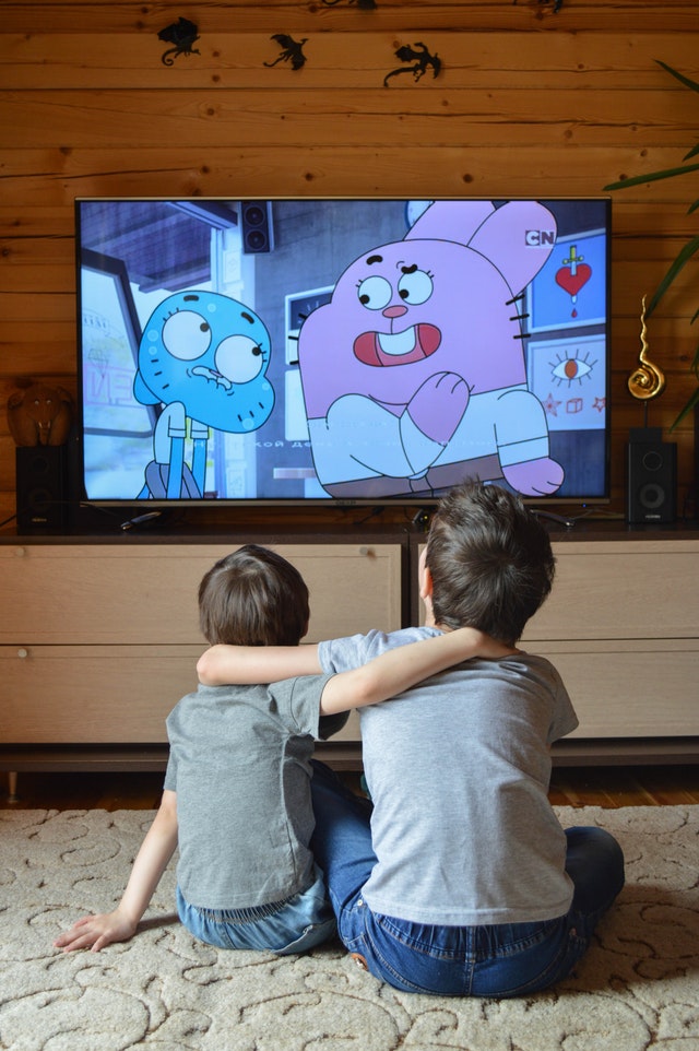 Two boys watching TV. Routines are important for children with autism.