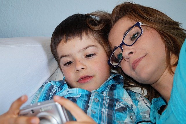 Mom snuggling with son. How do autism parents deal with judgement?