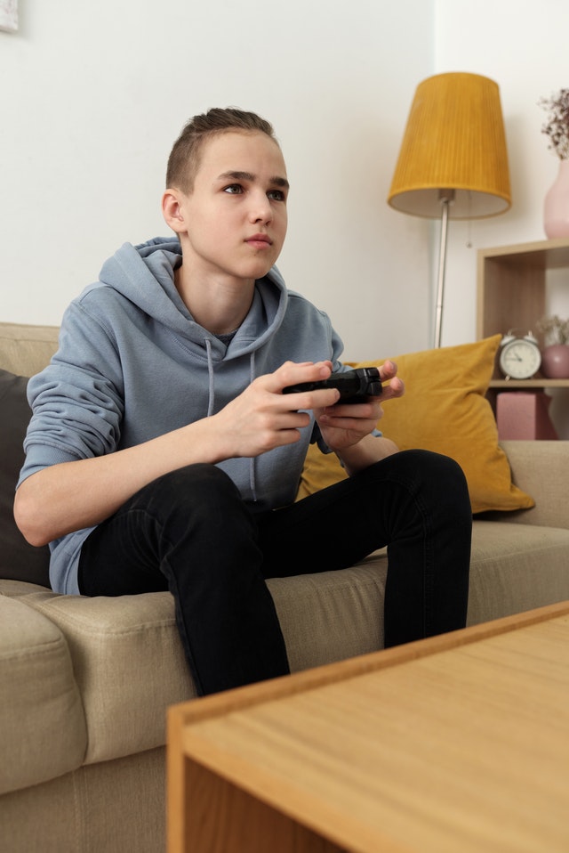 Teenage boy playing video games.