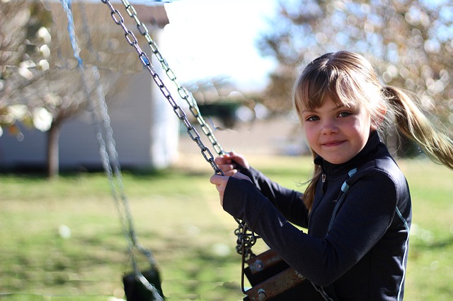 Girl on swing. Help your child with autism and ADHD manage sensory issues.