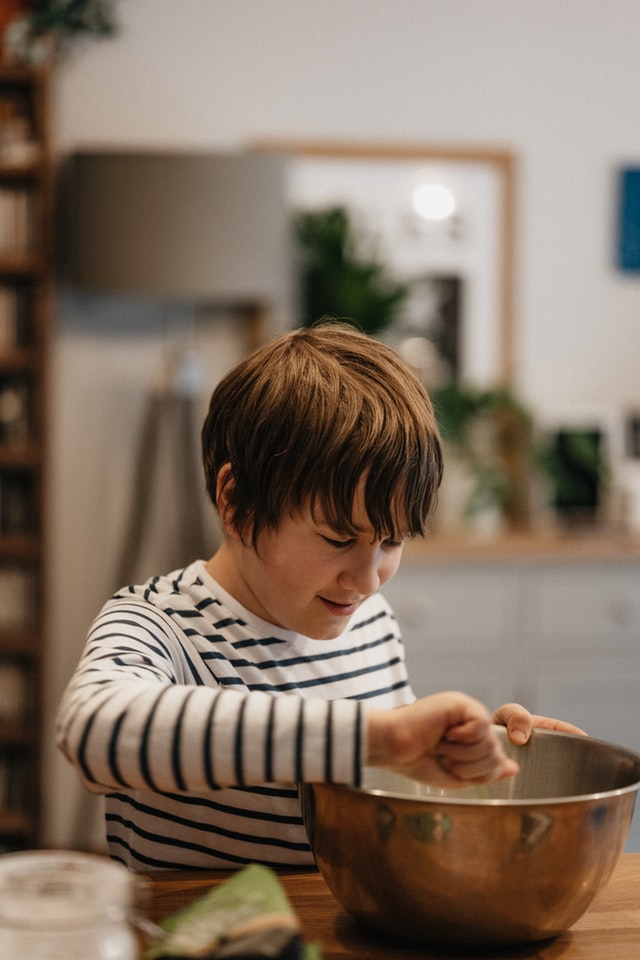 Teen boy cooking. How to build independence in your teenager with autism and ADHD.