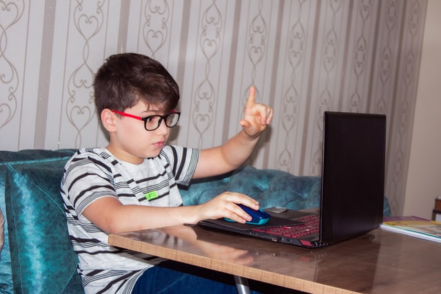 Boy on computer. Ensure Internet safety for your teenager with autism.