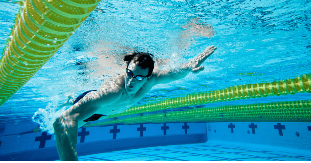 Teenage boy swimming in pool. Consider Special Olympics for your teenager with autism.