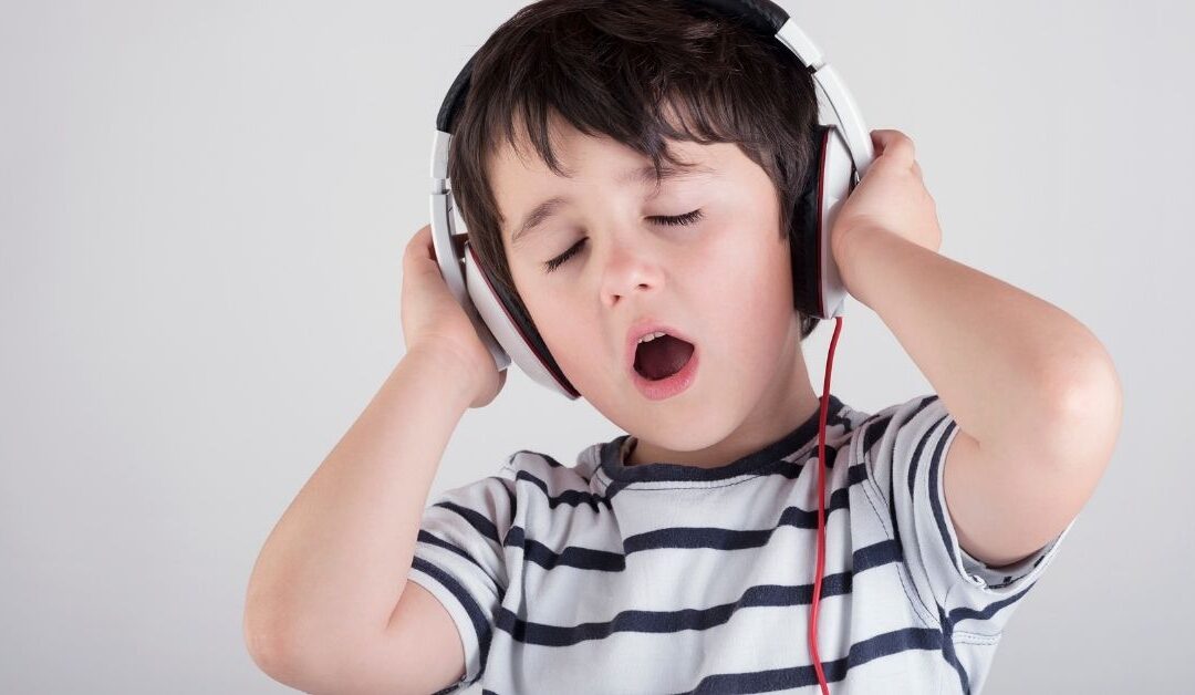 Boy wearing headphones. Music can benefit your autistic child.