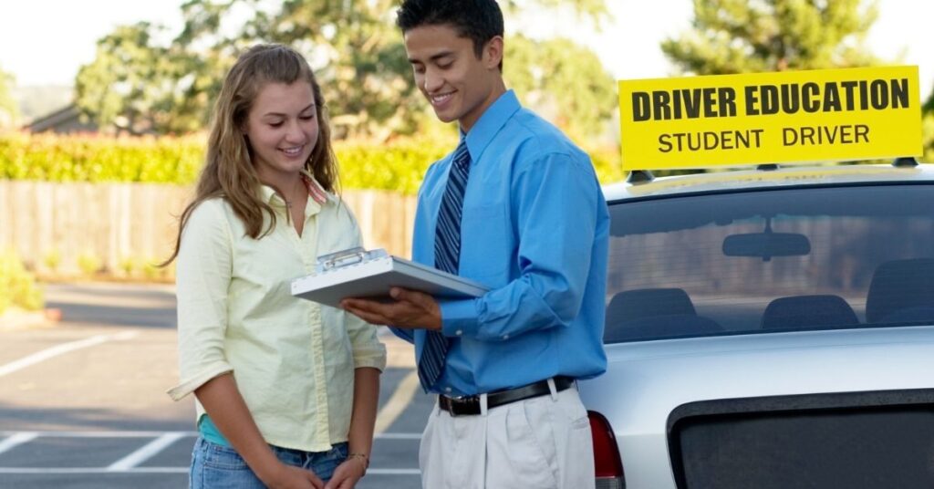 Teenage girl talking to a driver instructor.