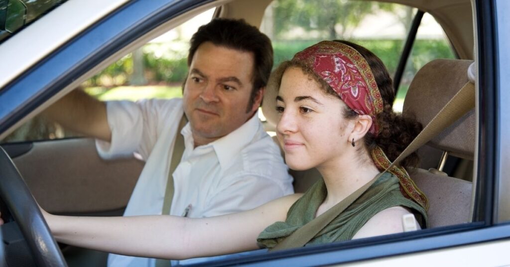 Teenage girl driving with instructor. Is your teen with autism and ADHD ready for driving?