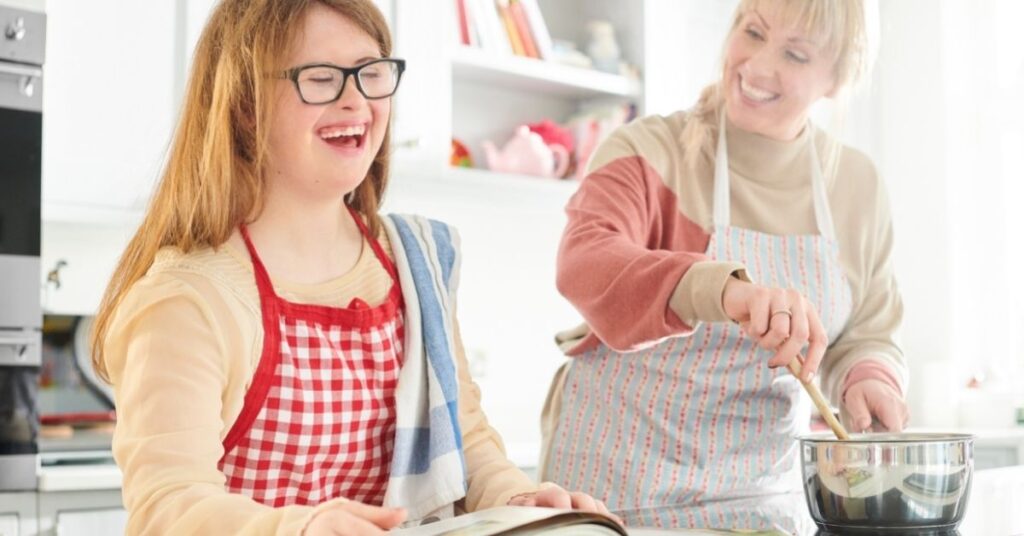 Teenage girl helping an adult cook. It's important to teach life skills to your autistic teenager.