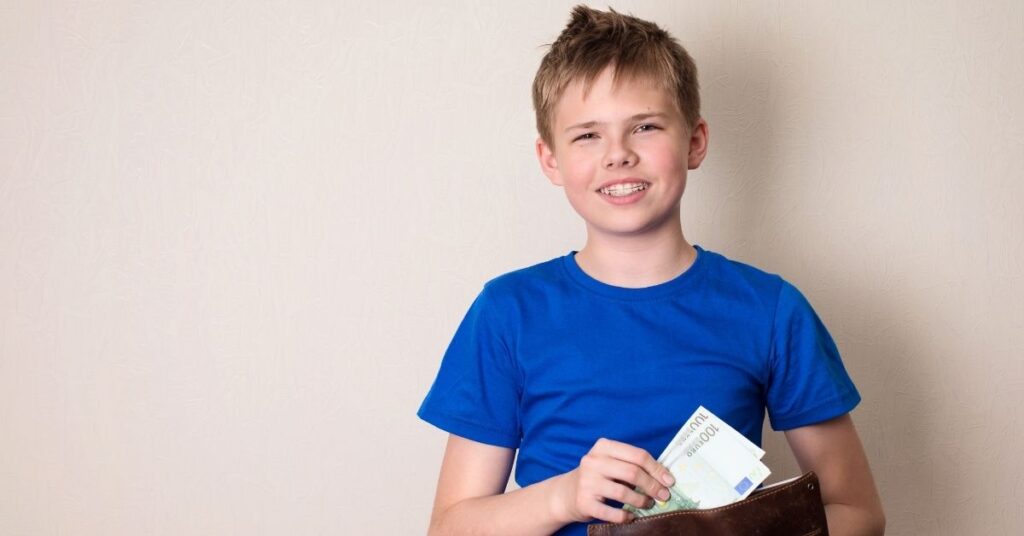Teenage boy hold a wallet and cash. It's important to teach your autistic teenager life skills.