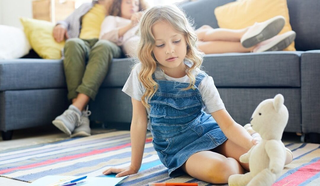 Girl sitting on floor with stuffed bunny.