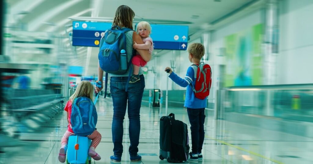 Family at the airport. Mom with three kids. How to prepare your child with autism and ADHD for an airplane flight.