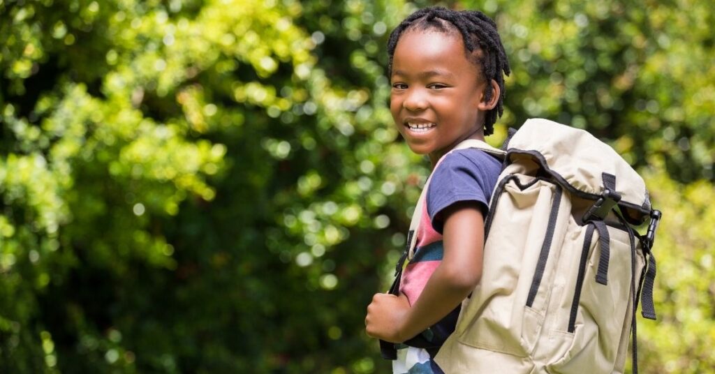 Boy carrying backpack. How to teach your autistic child or teen organization skills.