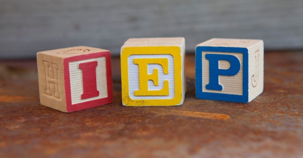 Toy blocks that spell out I-E-P. How can you effectively prepare for your autistic child's IEP meeting?