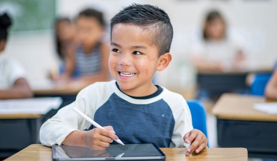 Boy using electronic table during class