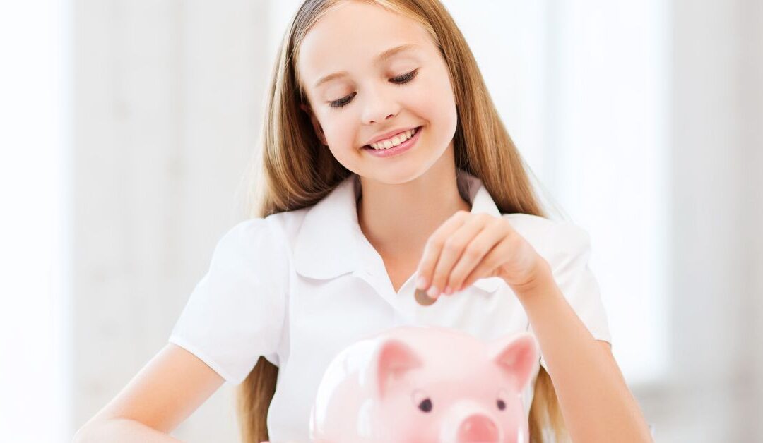 Teenage girl putting money in a piggy bank