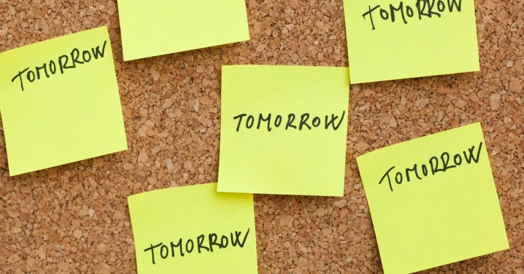 Corkboard with post-it notes saying "tomorrow" on it