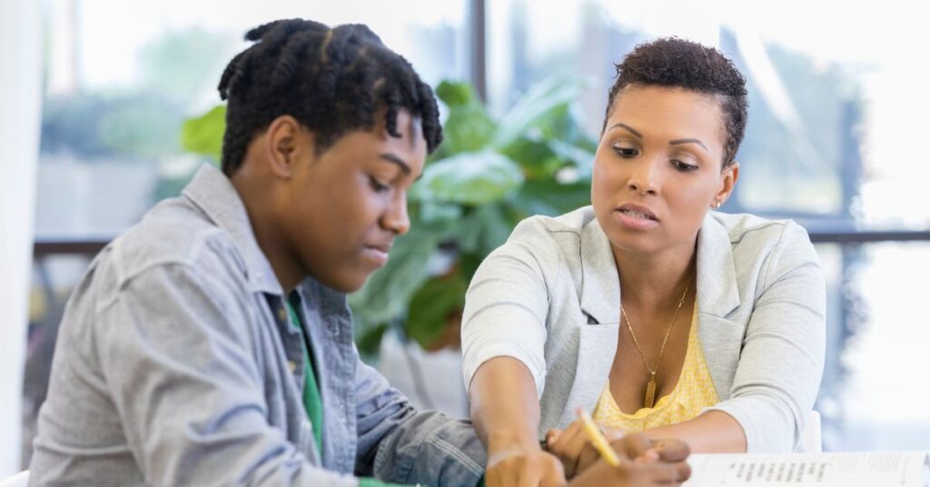 Mom sitting at table with teenage autistic son. How do you conquer your fear of your autistic child becoming an adult?