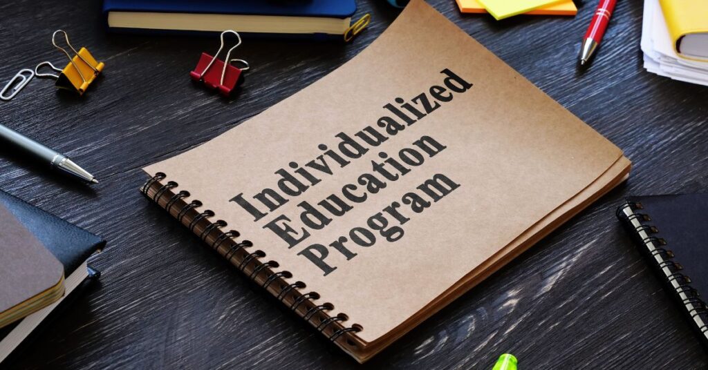 Bound notebook with "Individualized Education Plan" written on it. Be sure your autistic child's IEP is being followed at school.