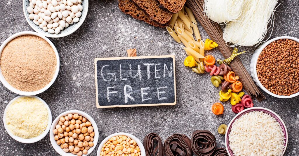 Image of chalkboard with "gluten free" written on it surrounded by bowls of ingredients