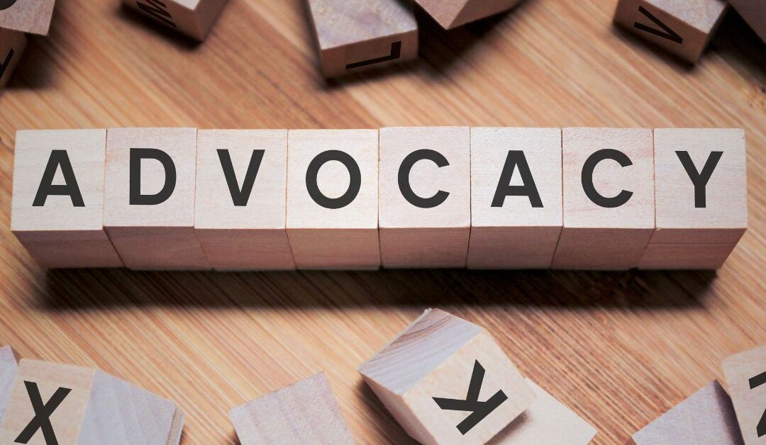 'ADVOCACY' spelled out in Scrabble letter blocks