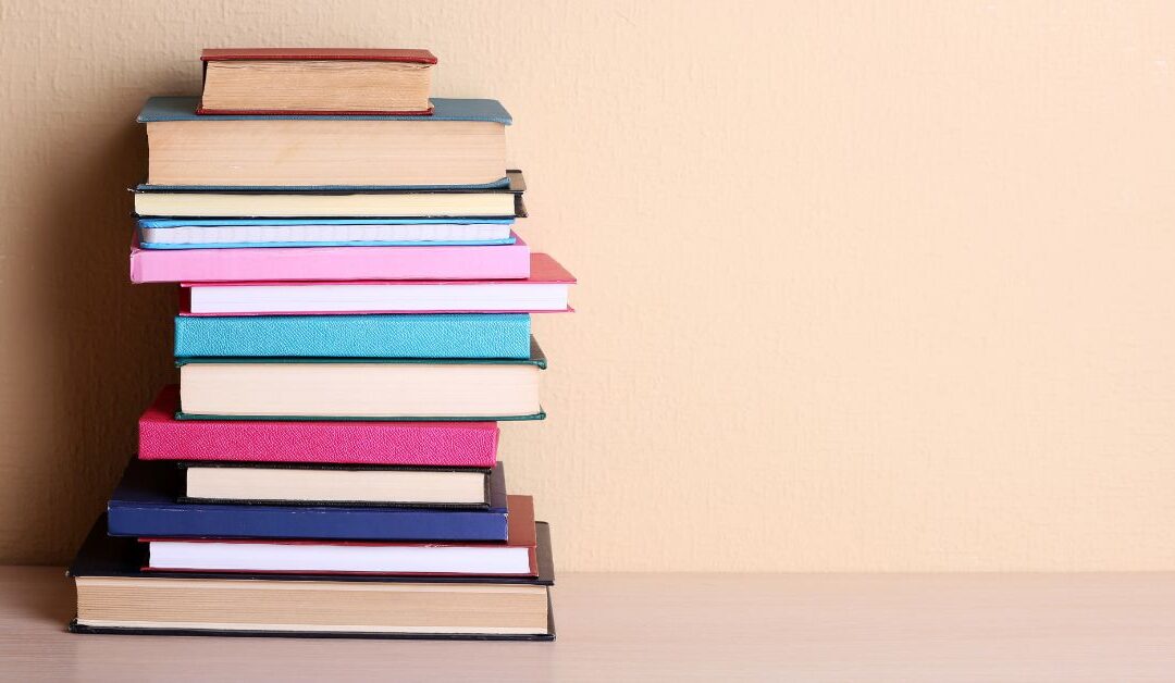 Stack of books. 10 books every parent of a child with autism and ADHD should read.