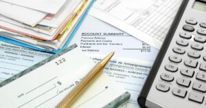 Bills, checkbook and calculator. How can you pay for all the care and services your child with autism and ADHD needs?