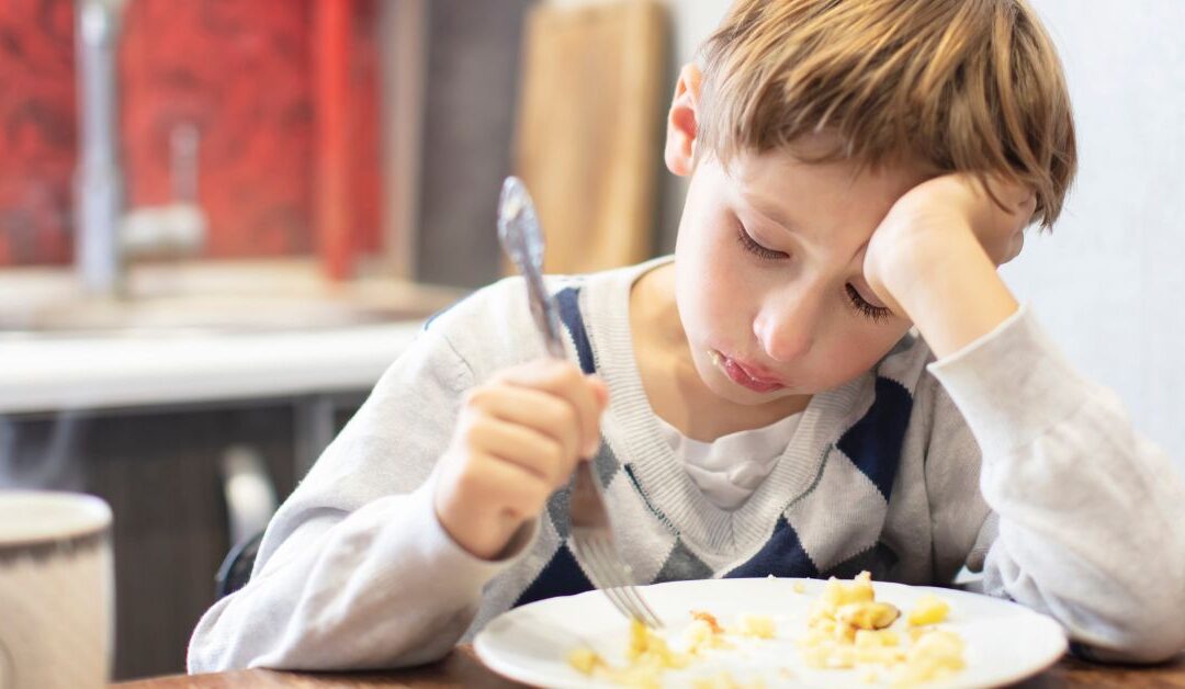 Boy moving food around his plate. When should you seek nutrition counseling for your child with autism?