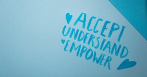 Blue paper that reads, "Accept, Understand, Empower." What does autism acceptance month mean to you as a parent of an autistic child?