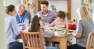 Extended family at the dinner table. How can you deal with family or friends who reject your child's autism diagnosis?