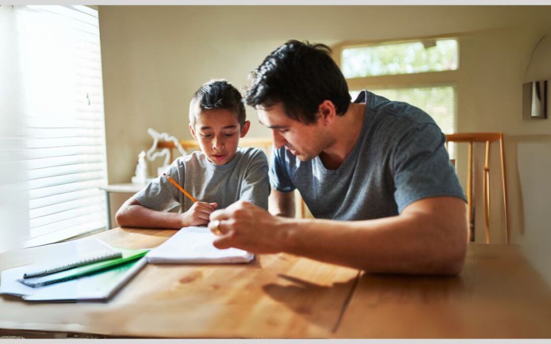 Dad helping boy with homework