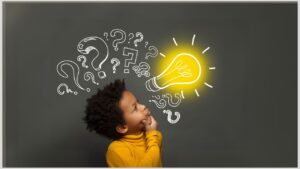 Little boy thinking in front of board with light bulb and question marks. Appreciate the positive aspects of how your autistic child thinks