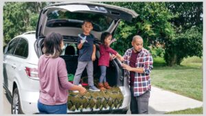 Family standing in back of an SUV with the hatch open